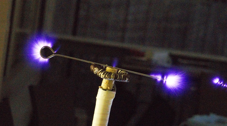 Electron discharge corona of the head of a tesla coil with a metal skewer balanced on top